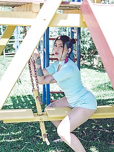 Girl Eating Cotton Candy In A Playground